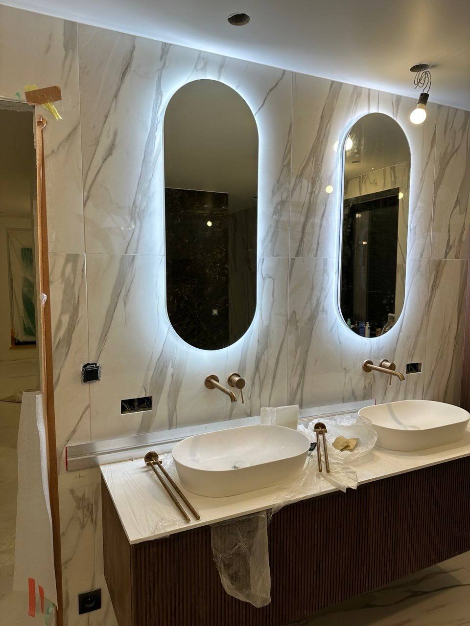 Double vanity with backlit mirrors